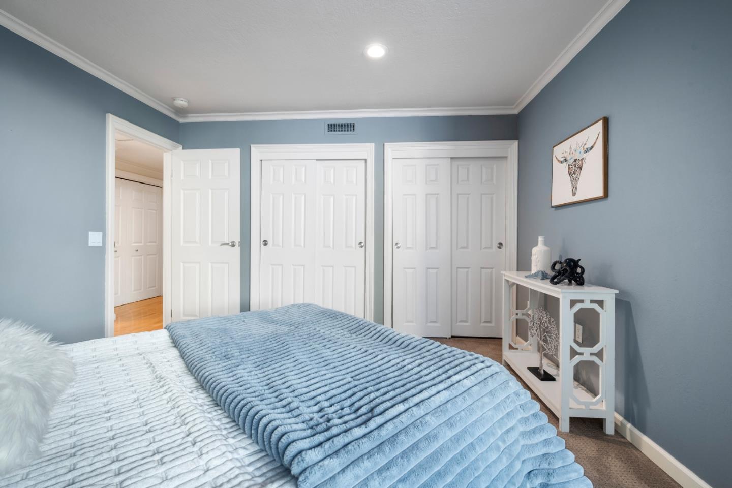 110 Park Road, Unit 103 Burlingame, CA 94010 - Photo 23 of 48 a spacious bedroom with a bed and a window