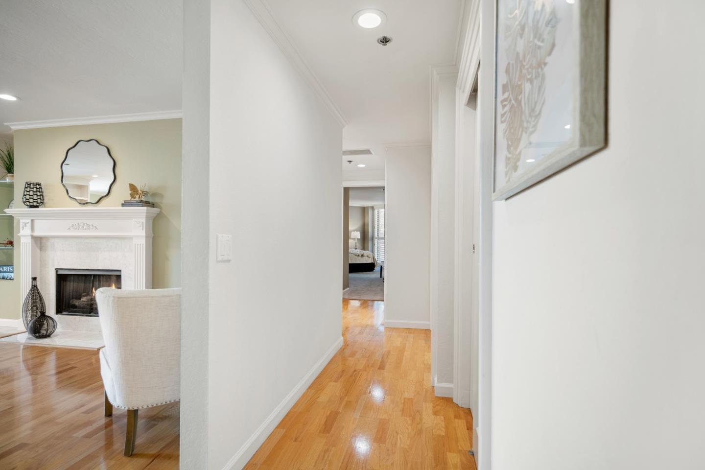 110 Park Road, Unit 103 Burlingame, CA 94010 - Photo 3 of 48 a view of a hallway with wooden floor and a fireplace