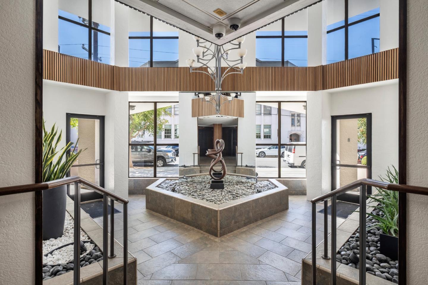 110 Park Road, Unit 103 Burlingame, CA 94010 - Photo 40 of 48 a living room with fireplace furniture and a chandelier