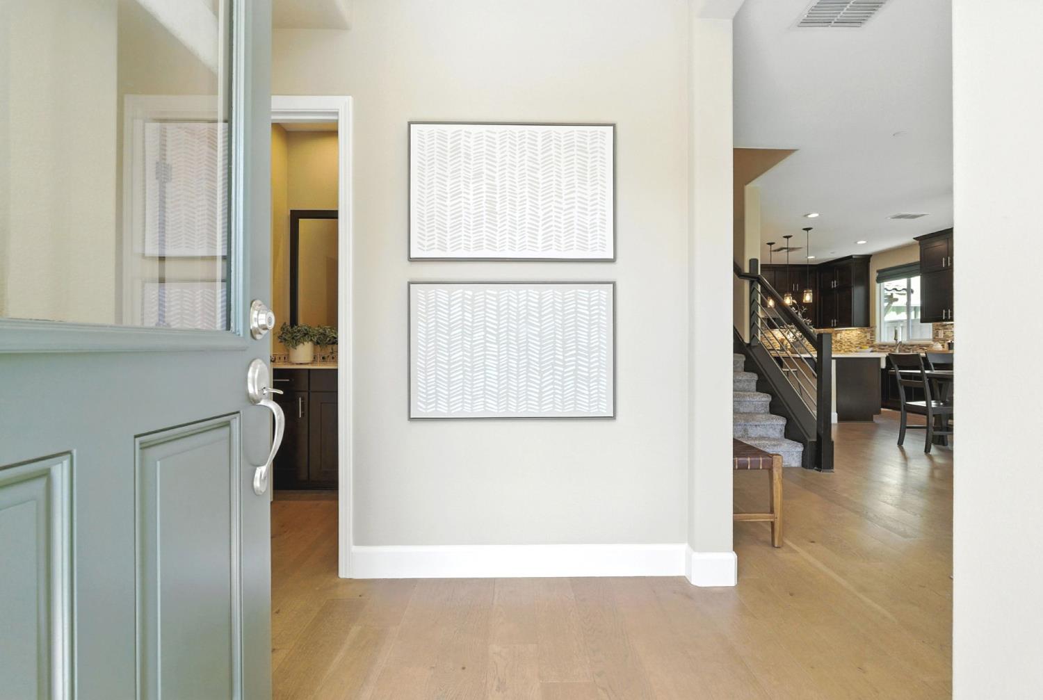 2248 Cannery Loop Davis, CA 95616 - Photo 3 of 34 a view of a hallway with wooden floor windows and a kitchen