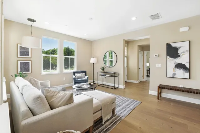 a living room with furniture fireplace and a window