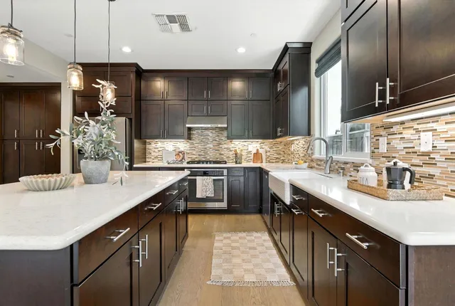 a kitchen with stainless steel appliances kitchen island granite countertop a sink counter space cabinets and a counter top space