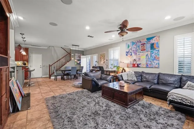a living room with furniture ceiling fan and a rug