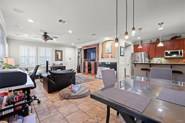 a living room with lots of furniture and kitchen view