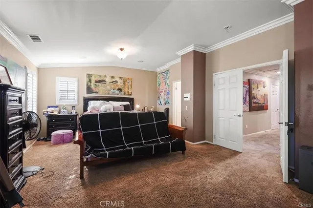 a bedroom with furniture and a flat screen tv