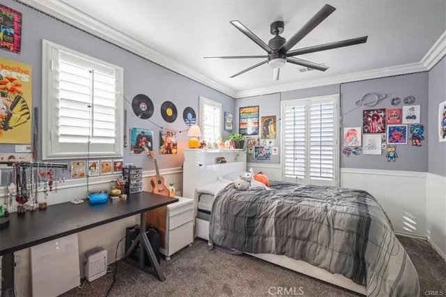 a bedroom with bed and a large window