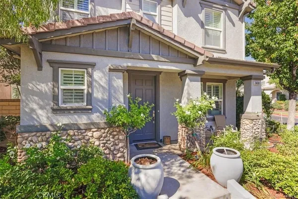 a front view of a house with a garden