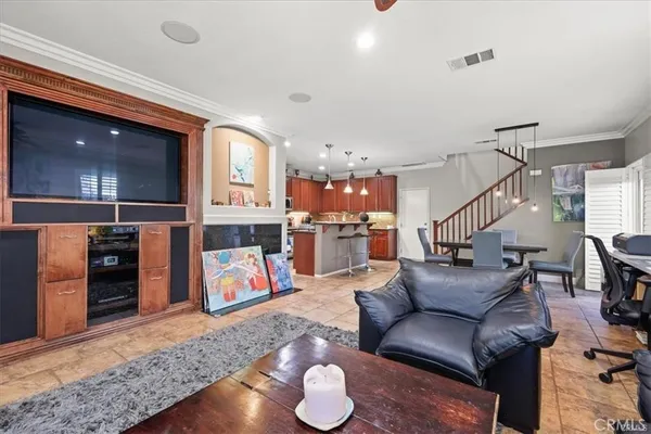 a living room with furniture and kitchen view