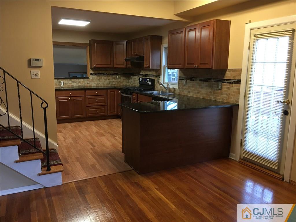 33 Back Drive Edison, NJ 08817 - Photo 2 of 25 a kitchen with stainless steel appliances granite countertop a stove a sink and a microwave