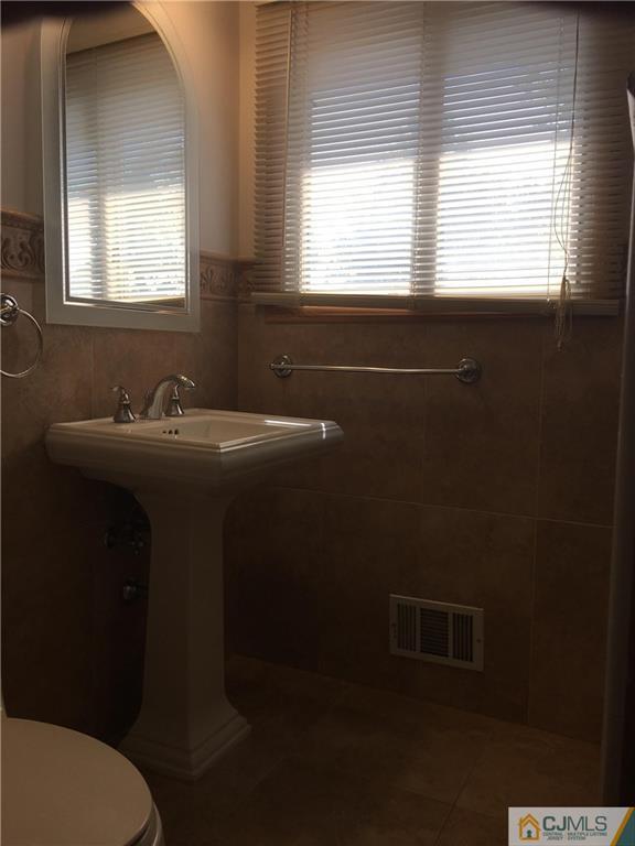 33 Back Drive Edison, NJ 08817 - Photo 16 of 25 a bathroom with a sink toilet and mirror