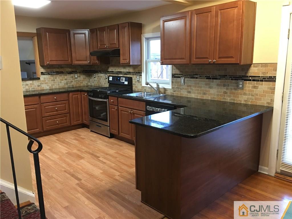33 Back Drive Edison, NJ 08817 - Photo 3 of 25 a kitchen with stainless steel appliances granite countertop a sink stove and cabinets