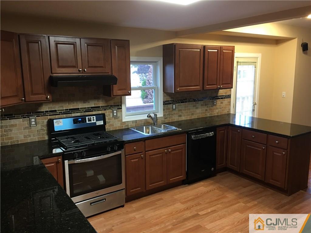 33 Back Drive Edison, NJ 08817 - Photo 4 of 25 a kitchen with a sink stove and microwave