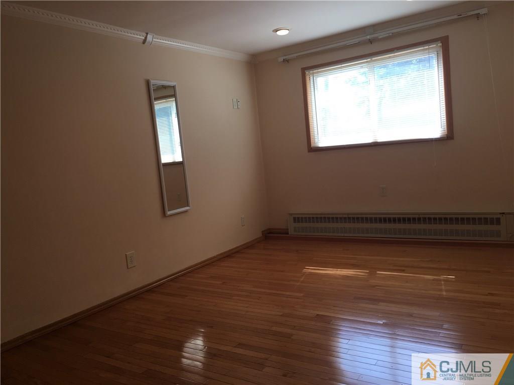 33 Back Drive Edison, NJ 08817 - Photo 9 of 25 a view of a room with wooden floor and window