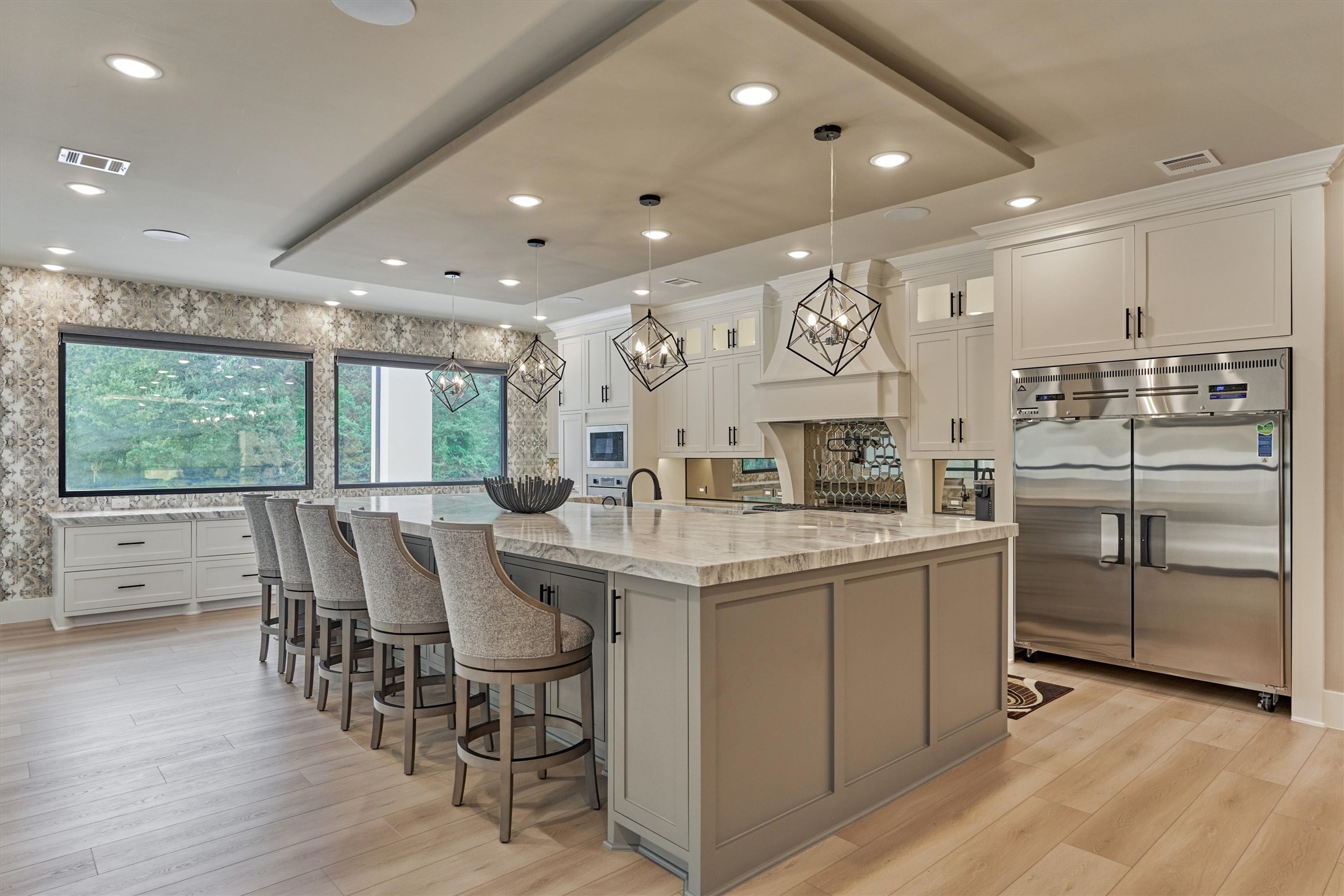 1907 Woerner Road Houston, TX 77090 - Photo 13 of 50 The main kitchen- 1 of 4 full kitchens in the home- is a showstopper with massive island with Quartzite countertops and ample seating.