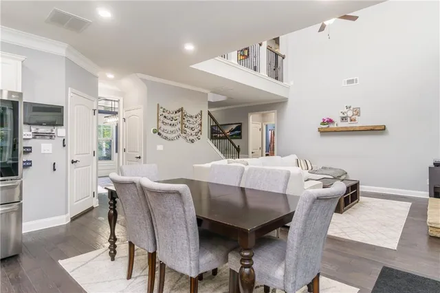 a view of a dining room with furniture and a chandelier
