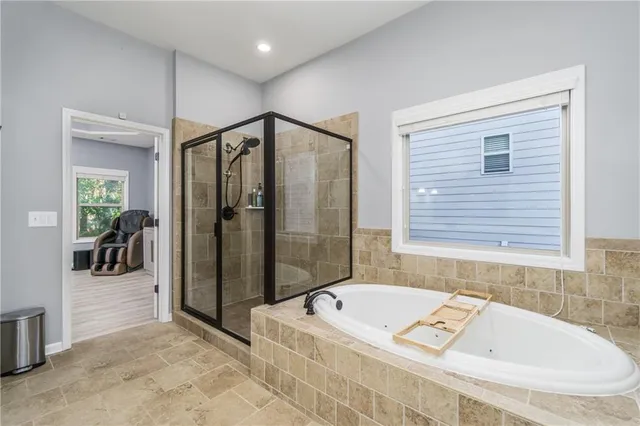 a bathroom with a tub a sink and a shower