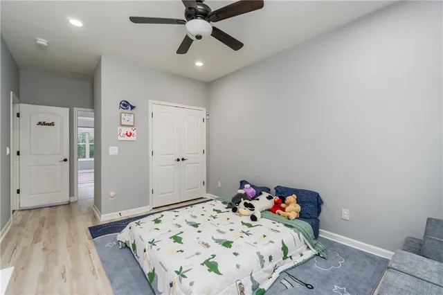 a bedroom with a bed and wooden floor