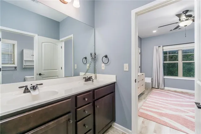 a spacious bathroom with a sink double vanity and a mirror