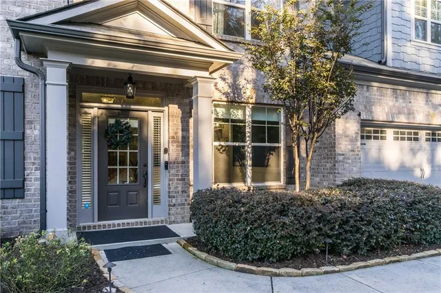 a view of a pathway of a house with a garden