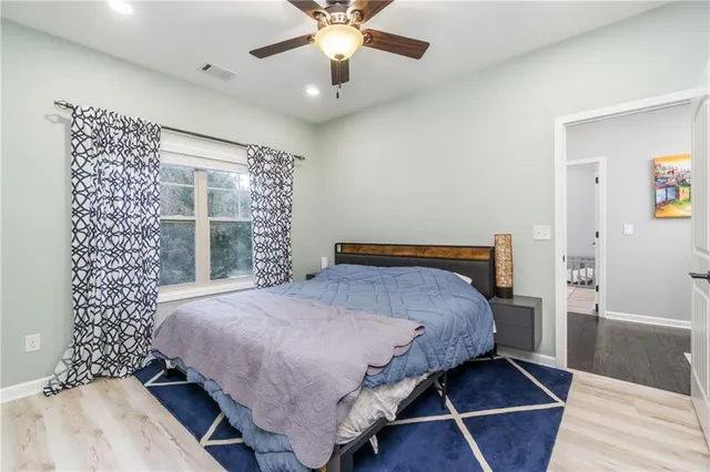 a bedroom with a bed and a window