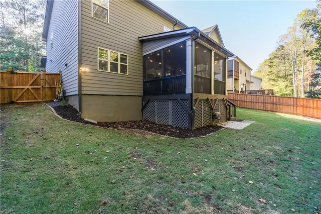 a view of a house with backyard and sitting area