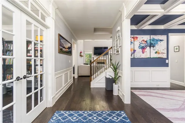 a view of entryway with furniture and wooden floor