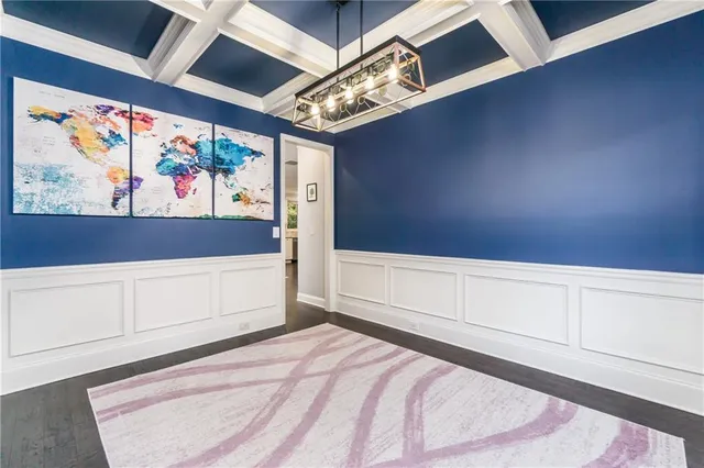 a view of a room with wooden floor and chandelier