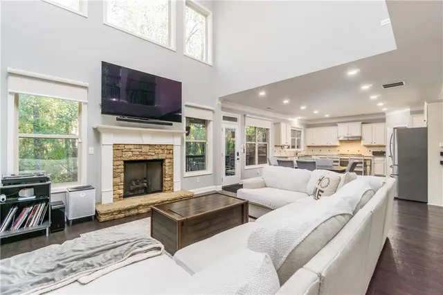 a living room with furniture fireplace and flat screen tv