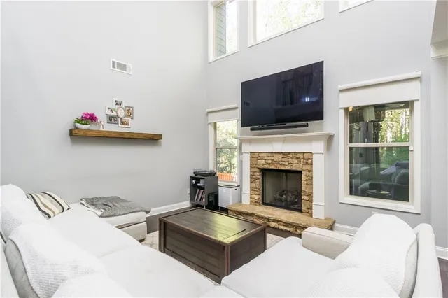 a living room with furniture fireplace and flat screen tv