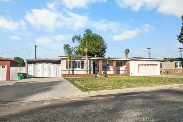 a view of a house with a yard and many windows