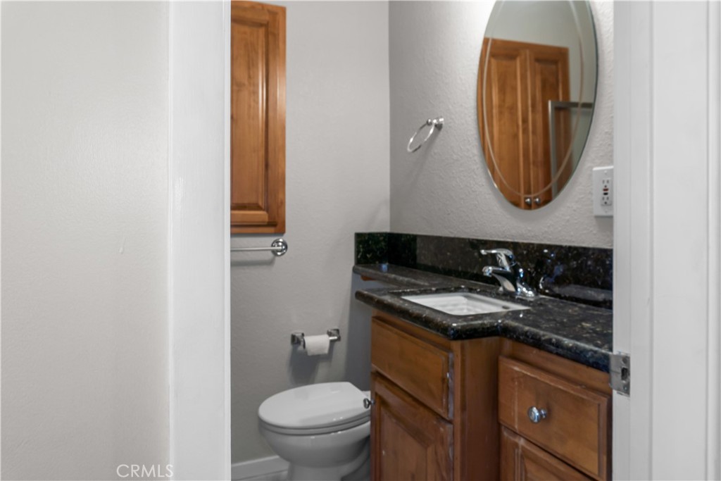 18811 East Weather Road Covina, CA 91722 - Photo 13 of 20 a bathroom with a granite countertop toilet and a sink