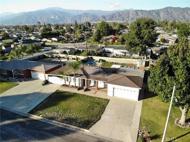 an aerial view of residential houses with outdoor space