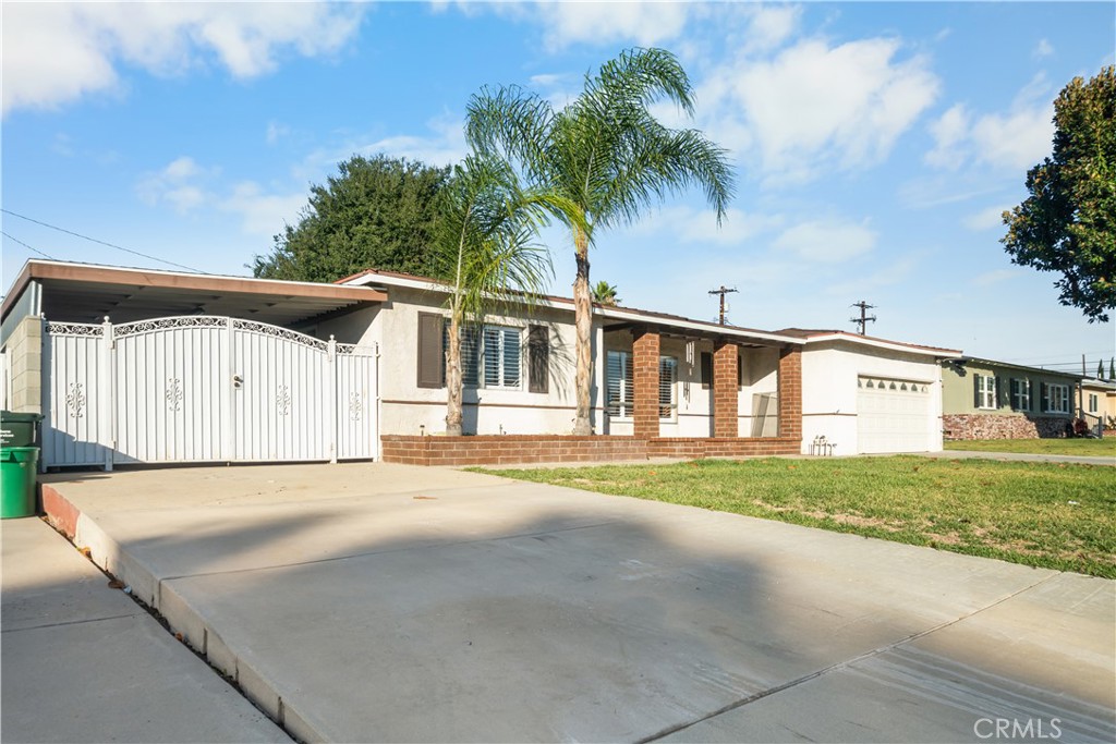 18811 East Weather Road Covina, CA 91722 - Photo 2 of 20 a front view of a house with a yard and garage