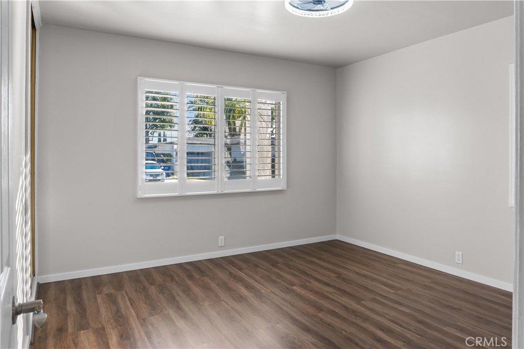 18811 East Weather Road Covina, CA 91722 - Photo 8 of 20 an empty room with wooden floor and windows