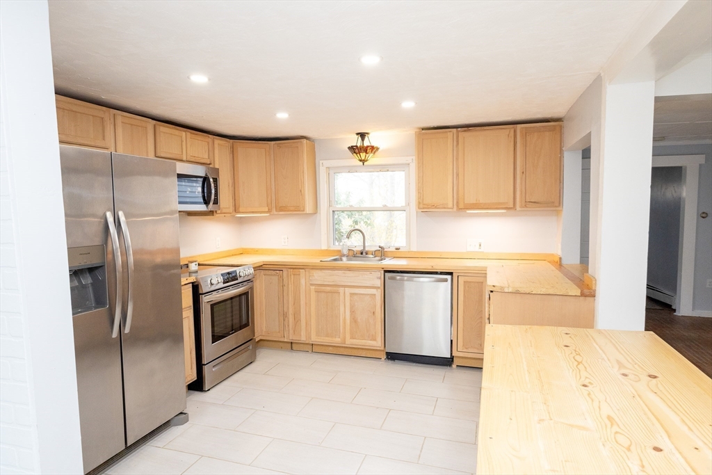 958 Center Street Middleboro, MA 02346 - Photo 2 of 17 a kitchen with stainless steel appliances granite countertop a refrigerator and a stove top oven