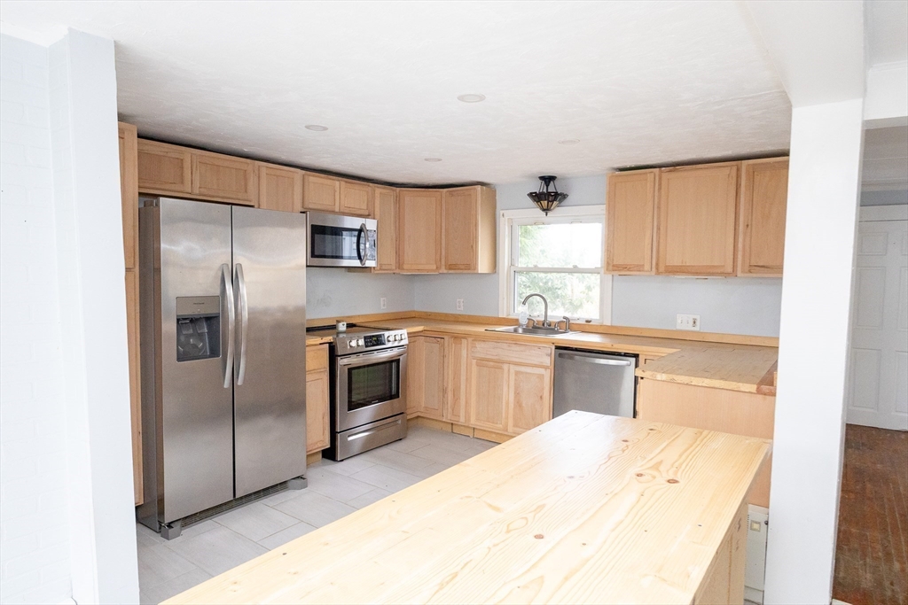 958 Center Street Middleboro, MA 02346 - Photo 3 of 17 a kitchen with a refrigerator sink and microwave