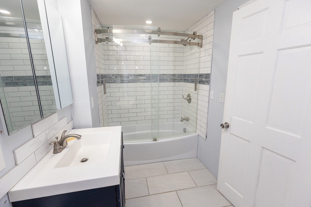 958 Center Street Middleboro, MA 02346 - Photo 4 of 17 a bathroom with a bathtub a sink a vanity and a shower