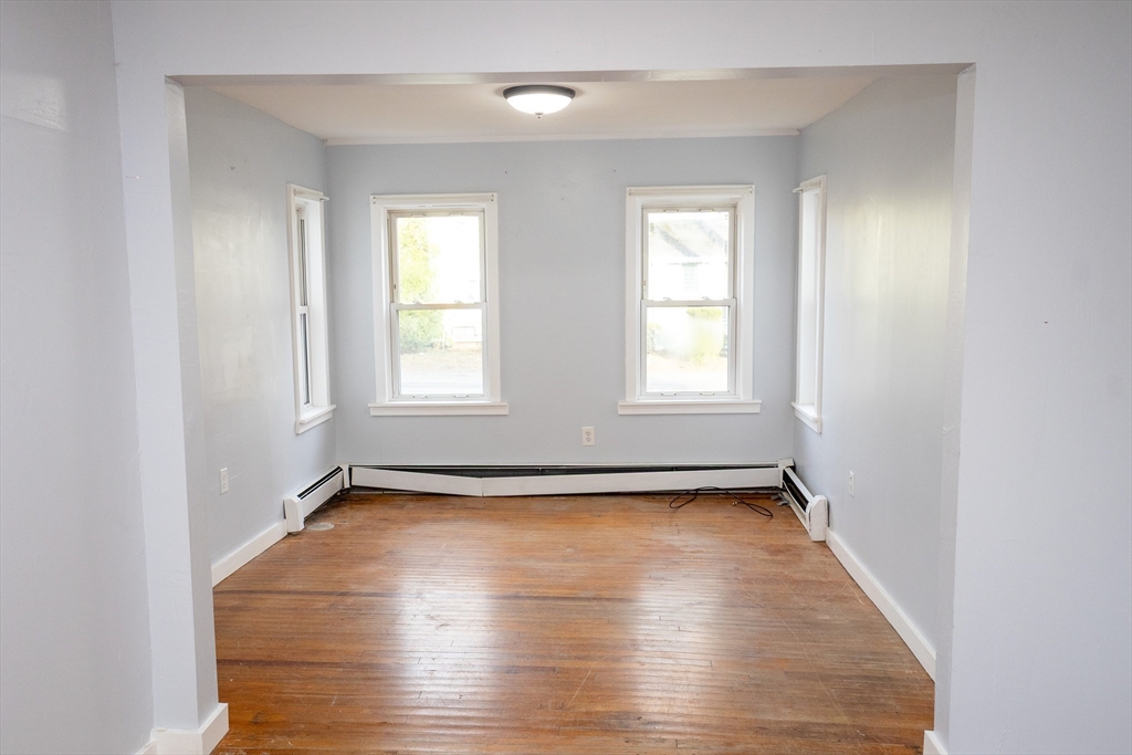 958 Center Street Middleboro, MA 02346 - Photo 6 of 17 an empty room with wooden floor and windows