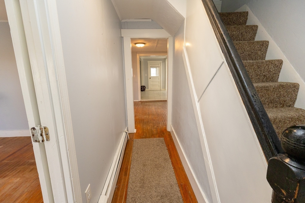 958 Center Street Middleboro, MA 02346 - Photo 10 of 17 a view of a hallway with wooden floor and staircase