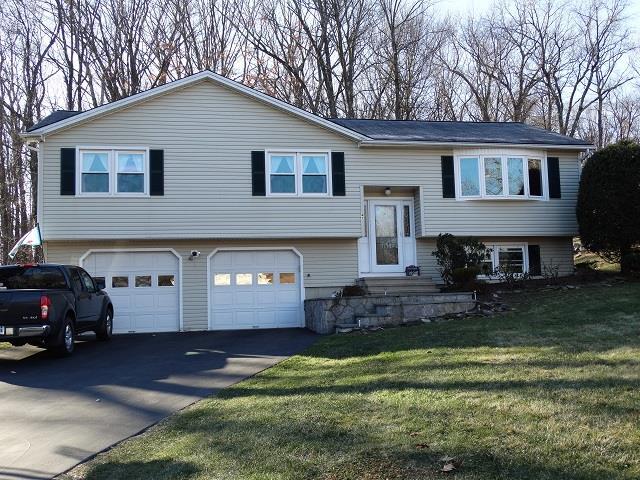 47 Oak Ridge Road Bethel, CT 06801 - Photo 1 of 1 a front view of a house with a yard