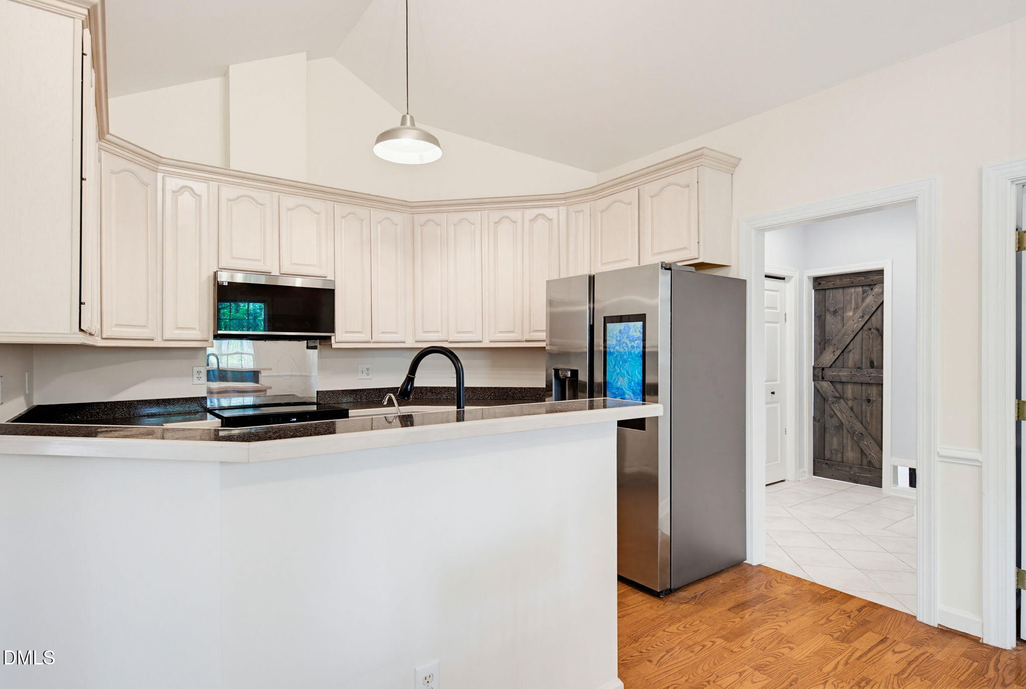 2533 Big Sky Lane Raleigh, NC 27615 - Photo 13 of 40 a kitchen with stainless steel appliances granite countertop a refrigerator stove microwave and sink