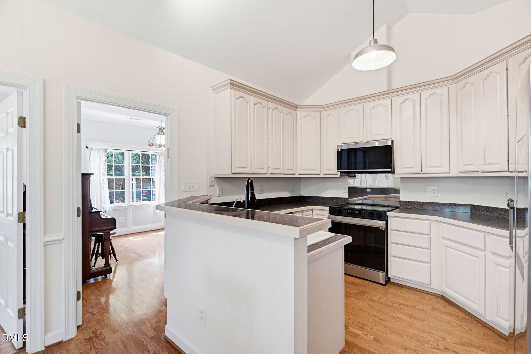2533 Big Sky Lane Raleigh, NC 27615 - Photo 16 of 40 a kitchen with stainless steel appliances granite countertop a stove top oven a sink dishwasher and a microwave oven on the blue kitchen countertops