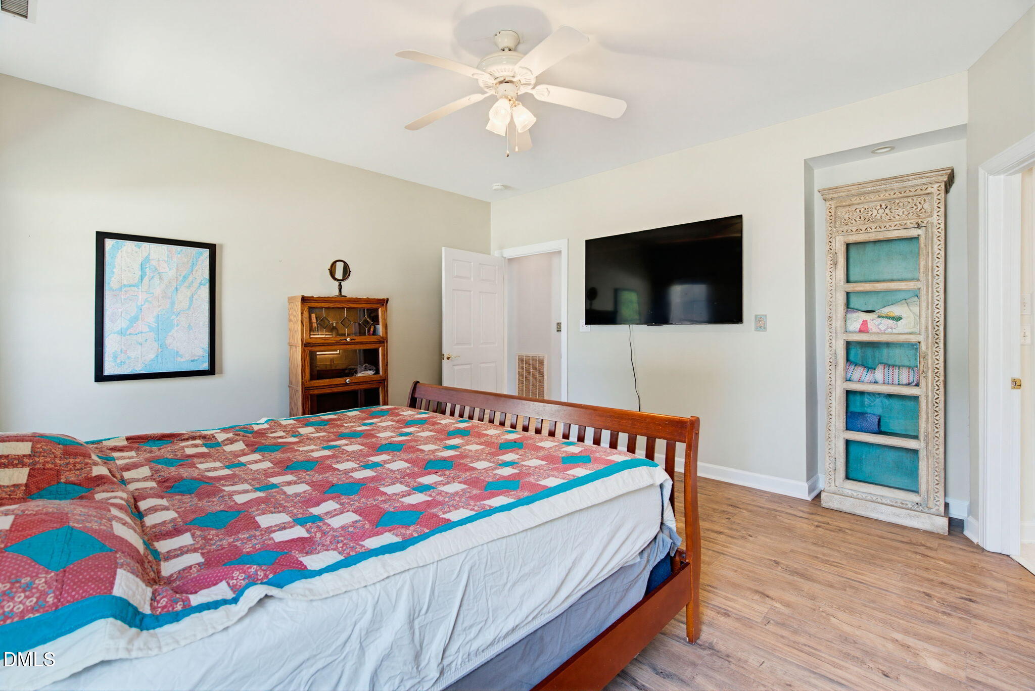 2533 Big Sky Lane Raleigh, NC 27615 - Photo 20 of 40 a bedroom with a bed a flat screen tv and a chandelier
