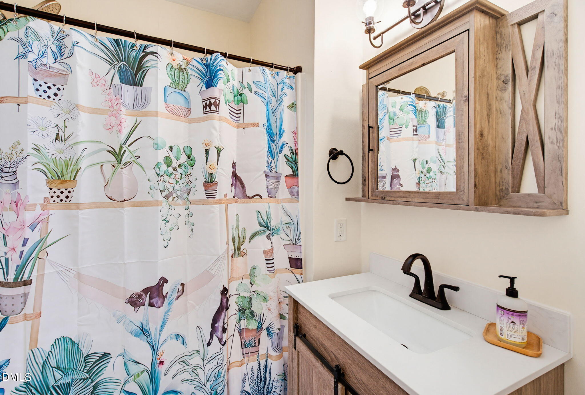 2533 Big Sky Lane Raleigh, NC 27615 - Photo 25 of 40 a bathroom with a sink and a mirror