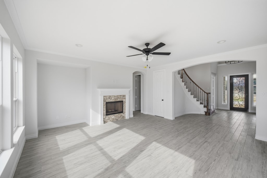 16511 Boston Post Road Cypress, TX 77429 - Photo 11 of 46 wooden floor in an empty room with a fireplace