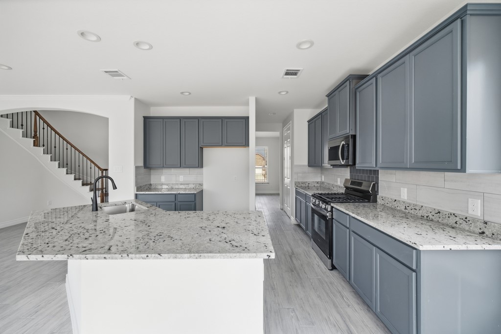 16511 Boston Post Road Cypress, TX 77429 - Photo 13 of 46 a kitchen with stainless steel appliances granite countertop a sink stove and refrigerator