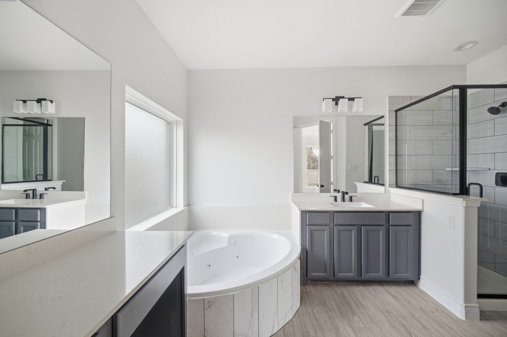 16511 Boston Post Road Cypress, TX 77429 - Photo 21 of 46 a bathroom with a tub sink and mirror
