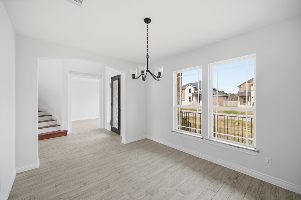 16511 Boston Post Road Cypress, TX 77429 - Photo 9 of 46 a view interior of a house with wooden floor ceiling fan and windows