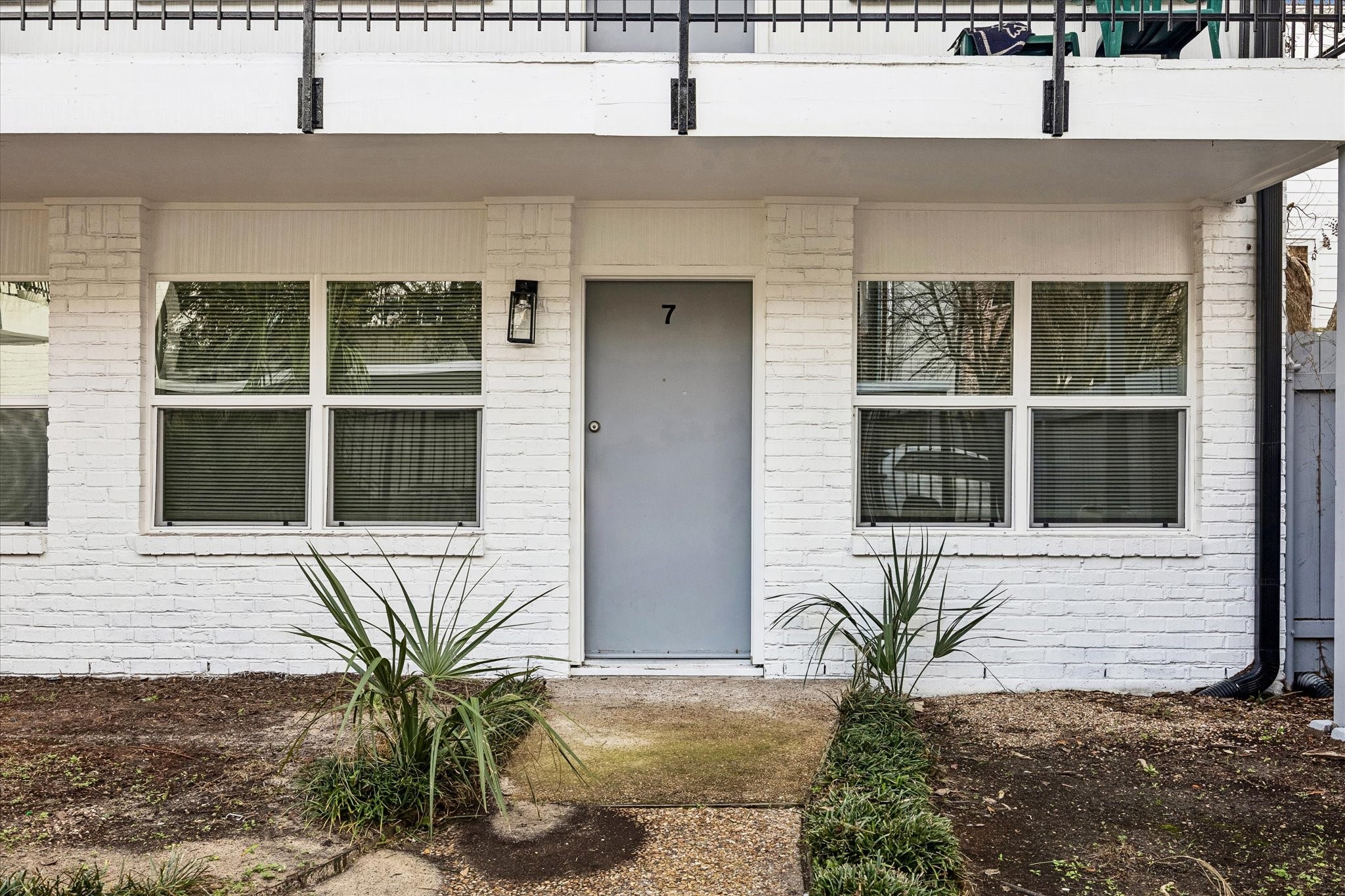 a potted plant sitting in front of a house
