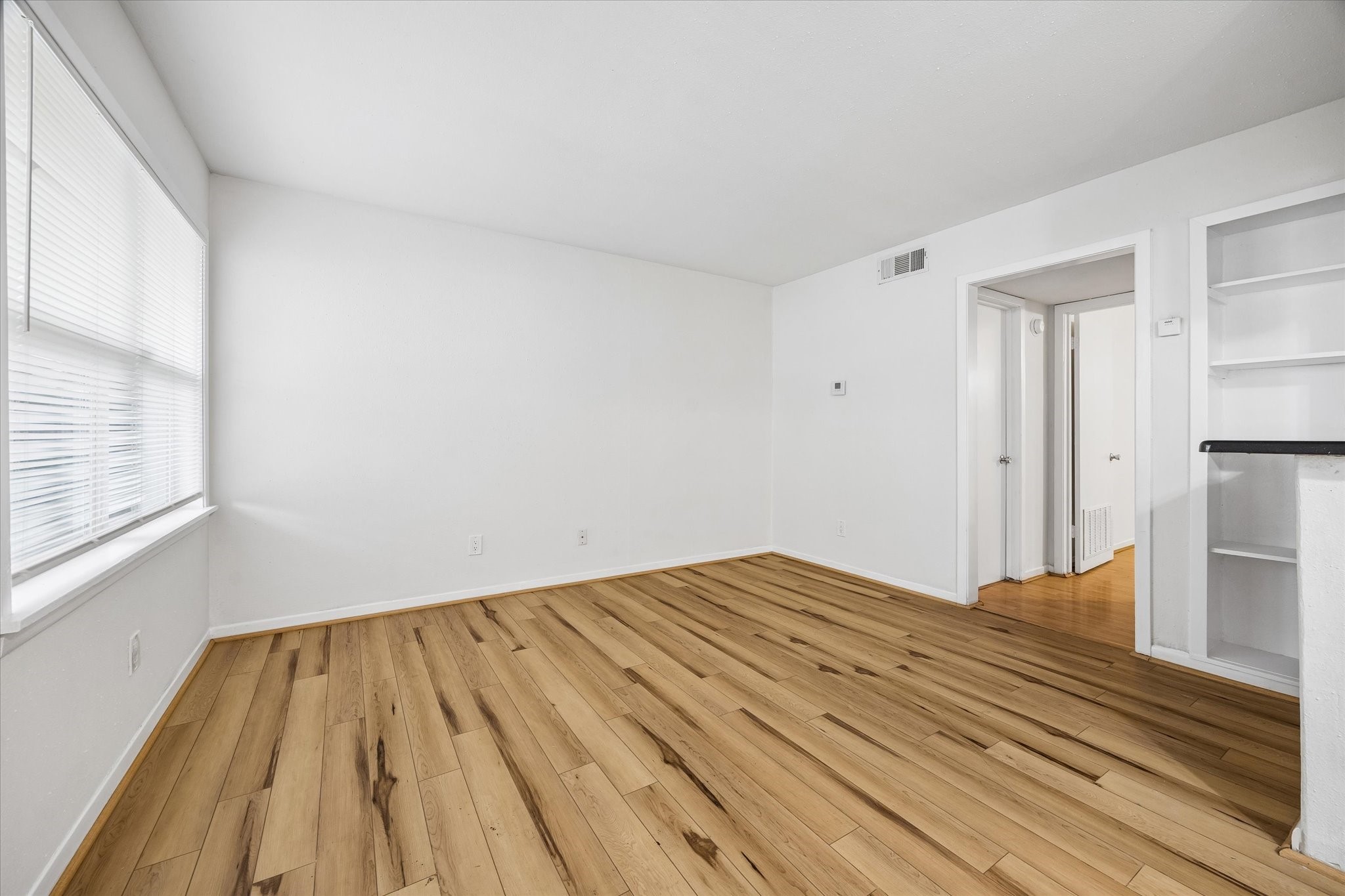 2206 Mason Street, Unit 7 Houston, TX 77006 - Photo 3 of 11 a view of empty room with wooden floor and fan